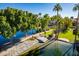 Peaceful waterfront view with a dock and lush greenery at 242 E Stonebridge Dr, Gilbert, AZ 85234