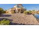 Landscaped backyard with stone and access to lake at 242 E Stonebridge Dr, Gilbert, AZ 85234