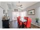 Bright dining room with red chairs and glass table, plus a view to the living room at 242 E Stonebridge Dr, Gilbert, AZ 85234