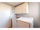 Laundry room with washer, dryer, and upper cabinets at 242 E Stonebridge Dr, Gilbert, AZ 85234
