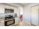 Kitchen boasts granite countertops, stainless steel appliances, and views to dining area at 242 E Stonebridge Dr, Gilbert, AZ 85234