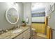 Clean bathroom with granite countertop, white cabinets, and yellow accents at 242 E Stonebridge Dr, Gilbert, AZ 85234