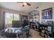 Home office with ample built-in shelving and two computer monitors at 242 E Stonebridge Dr, Gilbert, AZ 85234