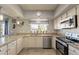 Bright kitchen with granite countertops, stainless steel appliances, and a breakfast bar at 242 E Stonebridge Dr, Gilbert, AZ 85234