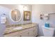 Bathroom with granite countertop, white cabinets, and an oval mirror at 242 E Stonebridge Dr, Gilbert, AZ 85234