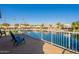 Deck with chairs and a view of lake and homes at 242 E Stonebridge Dr, Gilbert, AZ 85234