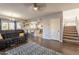 Open living space with hardwood floors, a view into the kitchen and staircase at 242 E Stonebridge Dr, Gilbert, AZ 85234