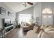Comfortable living room with hardwood floors, large TV and ample seating at 242 E Stonebridge Dr, Gilbert, AZ 85234
