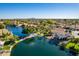 Wide aerial view of lakefront community with various homes at 242 E Stonebridge Dr, Gilbert, AZ 85234