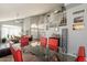 Spacious dining area with glass top table, red chairs, and loft view at 242 E Stonebridge Dr, Gilbert, AZ 85234