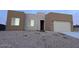 Two-story stucco home with a two-car garage and gravel landscaping at 11702 W Delwood Dr, Arizona City, AZ 85123