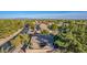 Aerial view showcasing a house with a backyard patio and shade sails, surrounded by lush trees and a neighborhood at 520 S Brett St, Gilbert, AZ 85296