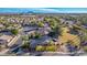 Aerial view of a house with a large backyard, situated in a residential area with surrounding greenery and distant mountains at 520 S Brett St, Gilbert, AZ 85296