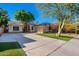 Beautiful home exterior with a two-car garage and lush lawn at 520 S Brett St, Gilbert, AZ 85296