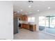 Modern kitchen featuring wood cabinets, stainless steel appliances, and sliding glass doors to the backyard at 7228 W Luke Ave, Glendale, AZ 85303