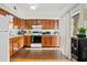 Bright kitchen featuring wood cabinets, appliances, and wood flooring at 8221 E Garfield St # L09, Scottsdale, AZ 85257