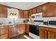 Kitchen features wood cabinets, granite counters and appliances at 8221 E Garfield St # L09, Scottsdale, AZ 85257