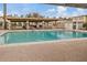 Community swimming pool with covered patio area and seating at 8221 E Garfield St # L09, Scottsdale, AZ 85257