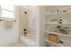 Well-appointed bathroom featuring built-in shelving, a bathtub, and modern fixtures at 4550 N 192Nd Dr, Litchfield Park, AZ 85340