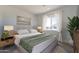 A comfortable bedroom with a large bed, nightstands, and natural light at 4550 N 192Nd Dr, Litchfield Park, AZ 85340