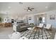 Open-concept living room with stylish furniture and decor, flowing seamlessly into the dining area at 4550 N 192Nd Dr, Litchfield Park, AZ 85340