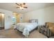 Comfortable bedroom with a full-size bed, chair, and access to bathroom at 725 S 81St Pl, Mesa, AZ 85208