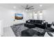 Living room features a sectional sofa, large TV, and fluffy rug at 4636 E Tierra Buena Ln, Phoenix, AZ 85032