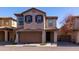 Two-story stucco home with brown garage door and landscaping at 4636 E Tierra Buena Ln, Phoenix, AZ 85032