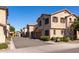 Row of tan townhouses with attached garages and landscaping at 4636 E Tierra Buena Ln, Phoenix, AZ 85032