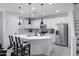 Modern kitchen with white cabinets, stainless steel appliances, and an island at 4636 E Tierra Buena Ln, Phoenix, AZ 85032