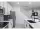 Sleek kitchen with white cabinets, black sink, and stainless steel appliances at 4636 E Tierra Buena Ln, Phoenix, AZ 85032