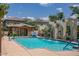Community pool with a stone water feature and surrounding patio at 4636 E Tierra Buena Ln, Phoenix, AZ 85032