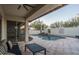 Relaxing pool area with covered patio, comfortable seating, and a tranquil waterfall feature at 1808 W Horsetail Trl, Phoenix, AZ 85085