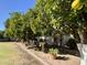 Landscaped backyard with fruit trees and stone pathway at 2222 N Val Vista Dr # 3, Mesa, AZ 85213