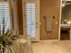 Bathroom with granite vanity, view to backyard, and door to bedroom at 2222 N Val Vista Dr # 3, Mesa, AZ 85213