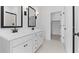 Modern bathroom with double vanity, black fixtures, and walk-in shower at 23387 W Albeniz Pl, Buckeye, AZ 85326