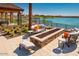 Inviting fire pit area with comfortable seating overlooking the lake at 24741 N 175Th Dr, Surprise, AZ 85387