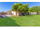 Landscaped backyard with grassy area and side yard at 12535 N 87Th Dr, Peoria, AZ 85381