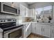 Bright kitchen with stainless steel appliances and white cabinetry at 158 W Commerce Ct, Gilbert, AZ 85233