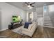 Comfortable living room featuring a beige sofa, flat-screen TV, and wood floors at 158 W Commerce Ct, Gilbert, AZ 85233