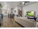 Spacious living room with beige sofa, large TV, and ceiling fan at 158 W Commerce Ct, Gilbert, AZ 85233