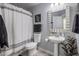 Clean bathroom with pedestal sink, shower/tub combo, and updated fixtures at 158 W Commerce Ct, Gilbert, AZ 85233