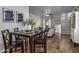 Cozy dining area with dark wood table and four chairs, near stairs and living room at 158 W Commerce Ct, Gilbert, AZ 85233