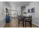 Open concept dining area with wood flooring and four chairs, next to kitchen at 158 W Commerce Ct, Gilbert, AZ 85233