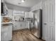 Modern white kitchen with stainless steel appliances and wood-look flooring at 158 W Commerce Ct, Gilbert, AZ 85233