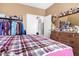 Bedroom with dresser, clothes rack and plaid bedding at 821 E Dry Creek Rd, San Tan Valley, AZ 85143