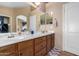 Bathroom with double vanity and wood cabinets at 821 E Dry Creek Rd, San Tan Valley, AZ 85143