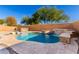 Inviting backyard pool with a waterfall feature and spa at 821 E Dry Creek Rd, San Tan Valley, AZ 85143