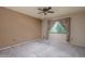 Simple carpeted bedroom with window and ceiling fan at 10829 W Hibiscus Dr, Sun City, AZ 85373