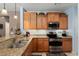 Kitchen with granite countertops, stainless steel appliances, and light wood cabinets at 21613 N 261St Ave, Buckeye, AZ 85396